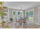 Bright breakfast nook features tile flooring, a glass table and large windows overlooking the backyard at 2721 Dahlgreen Rd, Raleigh, NC 27615