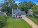 Charming two-story home with an attached garage, and a lush front lawn, all beneath a bright, sunny sky at 2721 Dahlgreen Rd, Raleigh, NC 27615