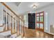 Bright foyer showcasing hardwood floors, staircase, and view to dining area at 2721 Dahlgreen Rd, Raleigh, NC 27615