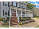 Inviting home featuring a charming front porch with brick steps and an orange front door at 2721 Dahlgreen Rd, Raleigh, NC 27615