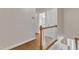 Upstairs hallway featuring wood floors, white doors and staircase at 2721 Dahlgreen Rd, Raleigh, NC 27615