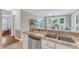 Kitchen with granite countertops, stainless dishwasher, and double basin sink overlooks the breakfast area at 2721 Dahlgreen Rd, Raleigh, NC 27615