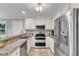 Modern kitchen with stainless steel appliances, granite countertops, and white cabinets for a sleek design at 2721 Dahlgreen Rd, Raleigh, NC 27615
