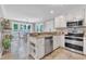 Bright kitchen with granite counters, stainless appliances, and an adjacent breakfast nook bathed in natural light at 2721 Dahlgreen Rd, Raleigh, NC 27615