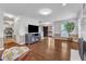 Open living room with hardwood floors, TV, and a seamless flow for entertaining at 2721 Dahlgreen Rd, Raleigh, NC 27615