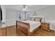 Spacious main bedroom featuring wood floors and a ceiling fan at 2721 Dahlgreen Rd, Raleigh, NC 27615