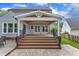 A view of the backyard showing a spacious covered patio and access to a stone patio area with outdoor seating at 2721 Dahlgreen Rd, Raleigh, NC 27615