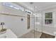Gorgeous shower with dual shower heads, gray mosaic tile floor, and natural light at 2721 Dahlgreen Rd, Raleigh, NC 27615