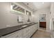 Bathroom featuring double sinks, vanity mirrors and under cabinet storage at 2721 Silver Stirrup Ln, Apex, NC 27502