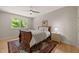 A cozy bedroom features a wood sleigh bed and a window with a view of greenery at 2721 Silver Stirrup Ln, Apex, NC 27502