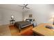 Bedroom with wood floors, neutral colors, ceiling fan, and adjacent work station at 2721 Silver Stirrup Ln, Apex, NC 27502