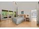 Spacious bedroom with calming colors, natural light, and forest views from multiple windows at 2721 Silver Stirrup Ln, Apex, NC 27502