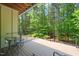 Outdoor deck with metal patio furniture and lush views of surrounding trees at 2721 Silver Stirrup Ln, Apex, NC 27502
