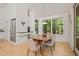 Well-lit dining room complemented by light wood floors, with built-in shelving and greenery views through large windows at 2721 Silver Stirrup Ln, Apex, NC 27502