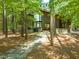 Stone pathway leads to the modern house situated on a lot surrounded by mature trees at 2721 Silver Stirrup Ln, Apex, NC 27502