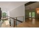 Bright foyer with glass railing adjacent sitting room with access to the outdoors at 2721 Silver Stirrup Ln, Apex, NC 27502