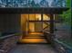 Modern home entrance with stone accents and illuminated wooden steps at 2721 Silver Stirrup Ln, Apex, NC 27502