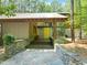 Inviting front entrance with stone accents, wooden porch, and a bright yellow door at 2721 Silver Stirrup Ln, Apex, NC 27502