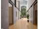 Modern hallway with skylight and exposed concrete walls leading to office area at 2721 Silver Stirrup Ln, Apex, NC 27502