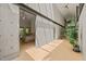 Spacious hallway leading to bedroom with unique concrete wall, ceiling fan, and wood floors at 2721 Silver Stirrup Ln, Apex, NC 27502