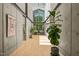 Bright hallway featuring concrete walls, skylight, wooden floors, and an open office space at 2721 Silver Stirrup Ln, Apex, NC 27502