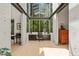 Sunlit home office features a large window with forest views, built-in desk, and contemporary furnishings at 2721 Silver Stirrup Ln, Apex, NC 27502