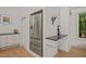 Kitchen nook with built-in desk, modern stainless steel refrigerator, and elegant white cabinetry at 2721 Silver Stirrup Ln, Apex, NC 27502