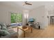Living room with stylish decor, light wood floors, and outdoor access to the deck at 2721 Silver Stirrup Ln, Apex, NC 27502