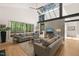 Bright, modern living room with skylights, concrete and steel beams, and nature views from large windows at 2721 Silver Stirrup Ln, Apex, NC 27502