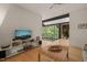 Living room with modern media center and scenic views of the foyer at 2721 Silver Stirrup Ln, Apex, NC 27502