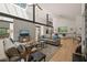 Bright, open-concept living room with skylights, concrete and steel beams, and nature views at 2721 Silver Stirrup Ln, Apex, NC 27502