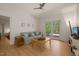 Cozy living room with neutral colors, a ceiling fan, and outdoor access at 2721 Silver Stirrup Ln, Apex, NC 27502