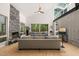 Bright living room with a vaulted ceiling, stone fireplace, and comfortable seating, offering serene views of the surrounding trees at 2721 Silver Stirrup Ln, Apex, NC 27502