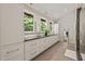A spacious bathroom with double vanities and views of the surrounding nature at 2721 Silver Stirrup Ln, Apex, NC 27502
