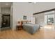 A modern main bedroom features wood floors, high ceilings, and an ensuite bathroom at 2721 Silver Stirrup Ln, Apex, NC 27502