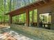 Covered patio featuring stone accents and comfortable seating with outdoor views at 2721 Silver Stirrup Ln, Apex, NC 27502