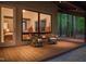 Inviting patio with wicker furniture overlooks the serene wooded surroundings and a glimpse into the bedroom at 2721 Silver Stirrup Ln, Apex, NC 27502