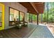 View of the porch with wicker rocking chairs, wood flooring, and exposed wood beam ceiling at 2721 Silver Stirrup Ln, Apex, NC 27502