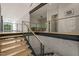 A modern staircase with glass railing connects the floors of the home at 2721 Silver Stirrup Ln, Apex, NC 27502