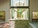 The view from the outside looking into the house through the floor-to-ceiling windowed atrium at 2721 Silver Stirrup Ln, Apex, NC 27502