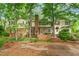 Exterior backyard of a traditional home, including brick patio, steps, and a well-maintained lawn at 3123 Amherst Ave, Burlington, NC 27215