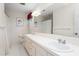 Well-lit bathroom with double sinks, white tile, and a large mirror at 3123 Amherst Ave, Burlington, NC 27215
