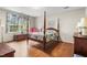 Bedroom featuring a four-poster bed, hardwood floors, and a bright window at 3123 Amherst Ave, Burlington, NC 27215