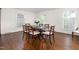 Well-lit dining room with a classic dining set and views from bright windows at 3123 Amherst Ave, Burlington, NC 27215