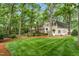 Exterior angle of house with well manicured lawn, trees, and a brick patio and covered entrance at 3123 Amherst Ave, Burlington, NC 27215