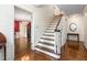 A staircase with hardwood steps and ornate trim in a traditional-style foyer at 3123 Amherst Ave, Burlington, NC 27215