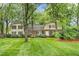 Charming home featuring a brick facade, manicured lawn and mature trees at 3123 Amherst Ave, Burlington, NC 27215