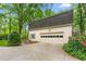 Spacious two-car garage with a classic design and well-lit driveway next to lush landscaping at 3123 Amherst Ave, Burlington, NC 27215