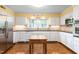 Traditional kitchen with white cabinets, matching appliances, and light-filled windows at 3123 Amherst Ave, Burlington, NC 27215