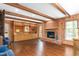 Spacious living room with wood paneled walls, brick fireplace, built-in shelves, and natural light at 3123 Amherst Ave, Burlington, NC 27215